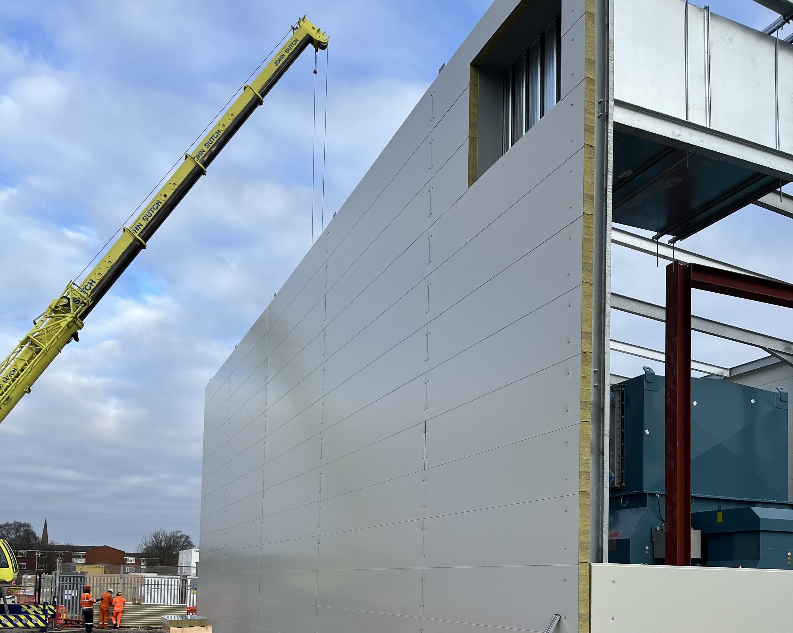 Acoustic panels being lifted into an acoustic enclosure