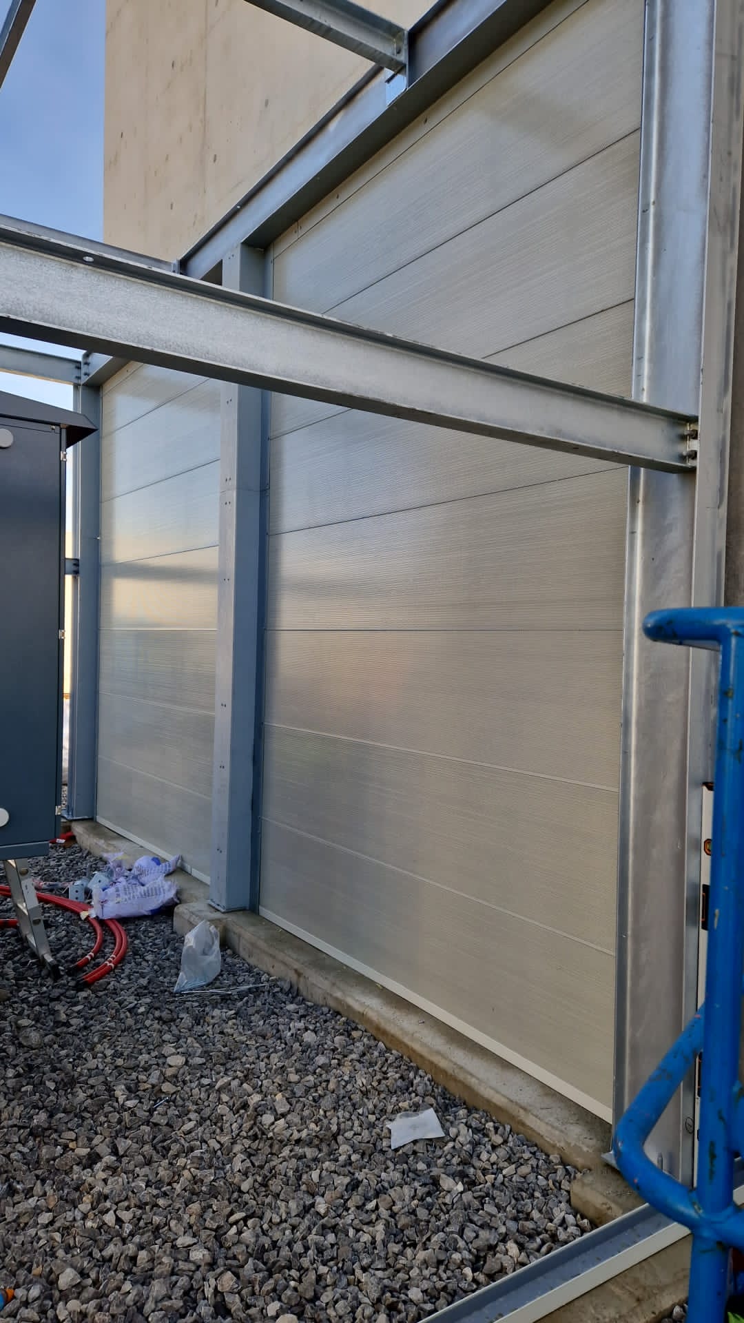 Perforated acoustic panels attached to steel structure
