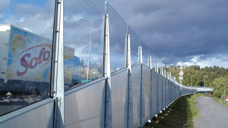 Road Barrier formed from steel acoustic panels